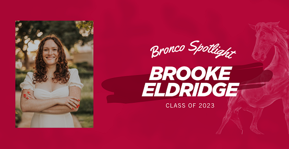 Woman standing with arms crossed.